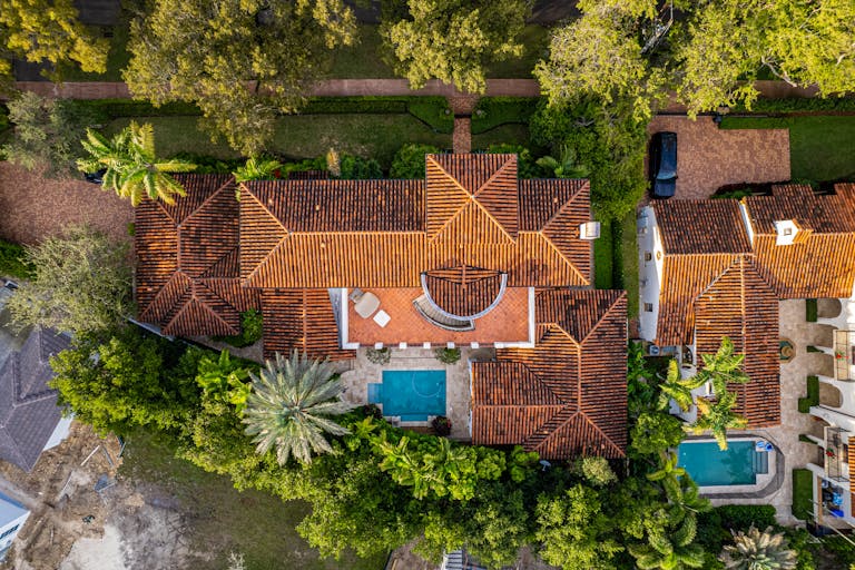 An aerial shot of a luxury home in Miami featuring a pool and lush greenery.