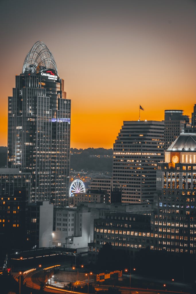 Beautiful Cincinnati skyline at sunset with illuminated skyscrapers and vibrant colors.