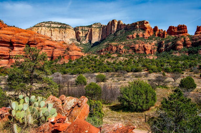 Breathtaking view of red rock formations and lush greenery in Sedona, Arizona.