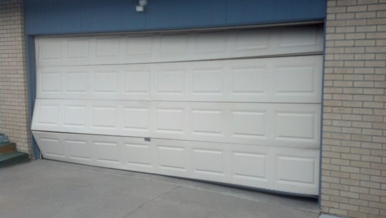 Damaged garage door in need of replacement or repair. Call now to schedule your repair or replacement 8552049688.