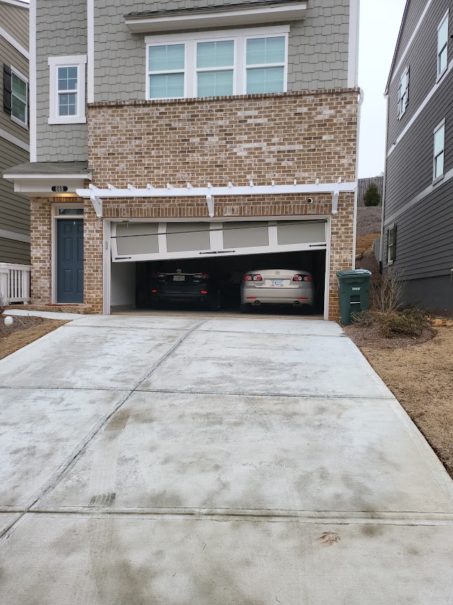 garage door clearly off track, seen from outside tilted to the left due to stage 5 track misalignment