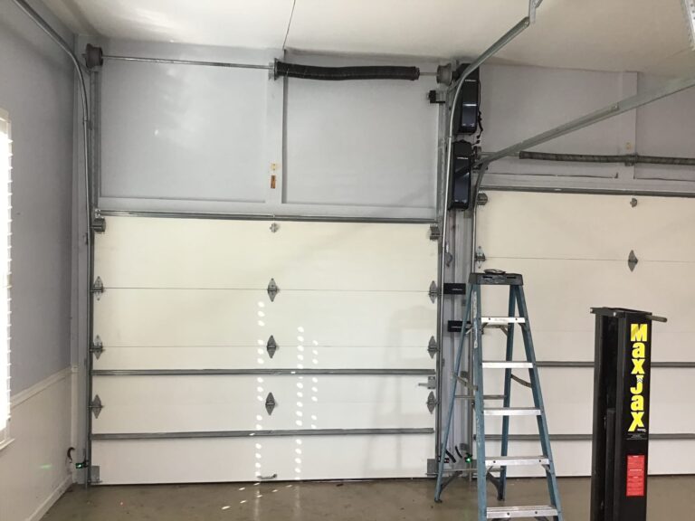highilift garage door installation seen beside normal door from the inside of the garage