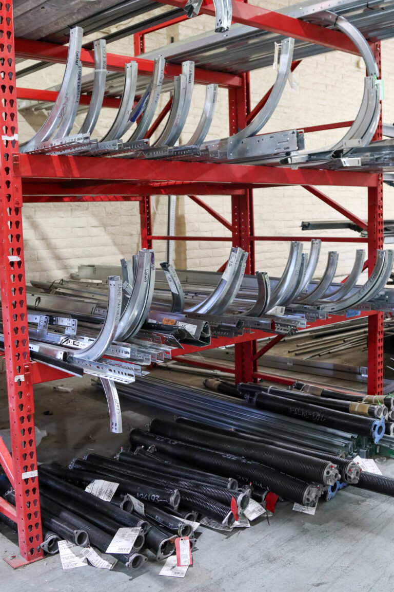 Garage door tracks on shelves in warehouse