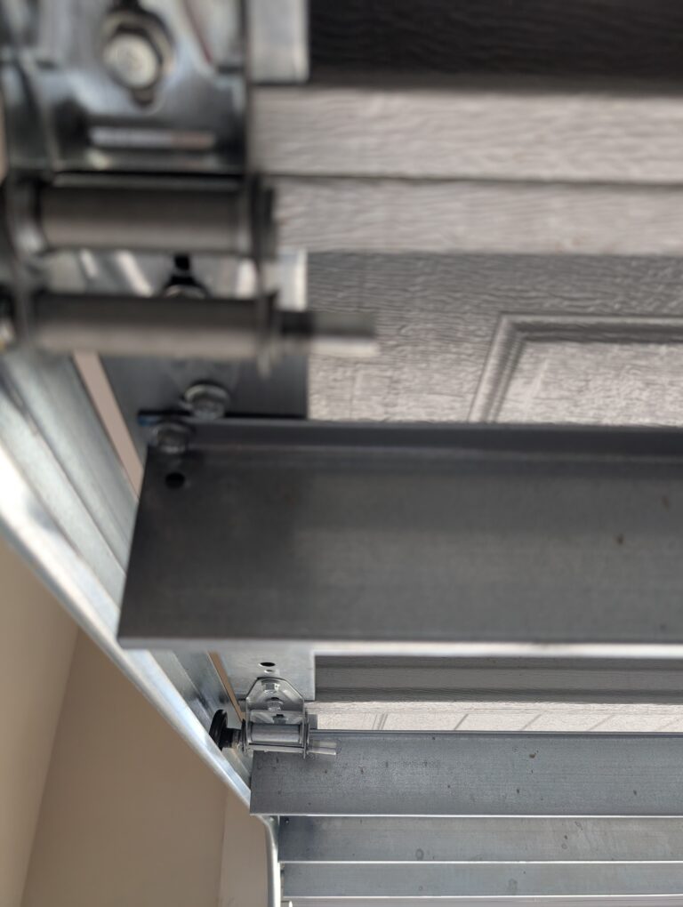 artistic view of garage door going up, garage door track, hinges, panels and rollers.