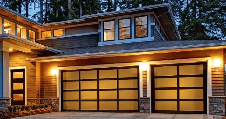 New modern home featuring glass panel garage doors in different sizes with wood trim in brown.