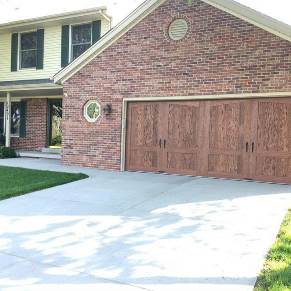 Older split level home with garage door replacement. New garage door displays improved curb appeal.